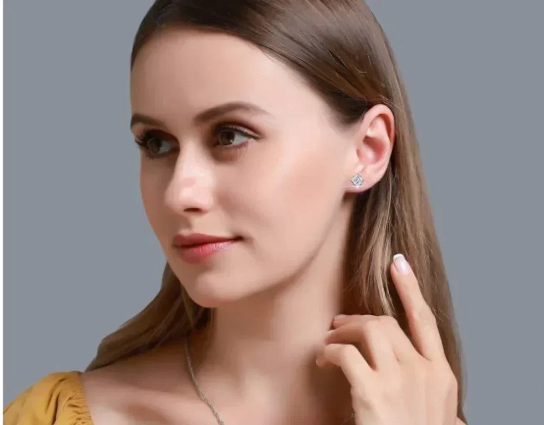 Woman wearing a square-cut diamond stud earring.