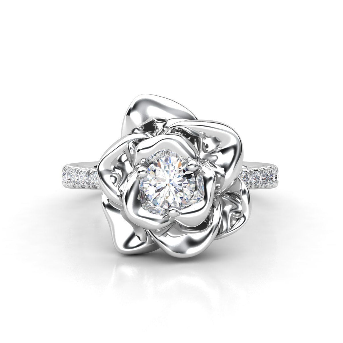 Floral-inspired diamond ring with sculpted metal petals and a brilliant solitaire centerpiece, accented with a diamond-studded band.