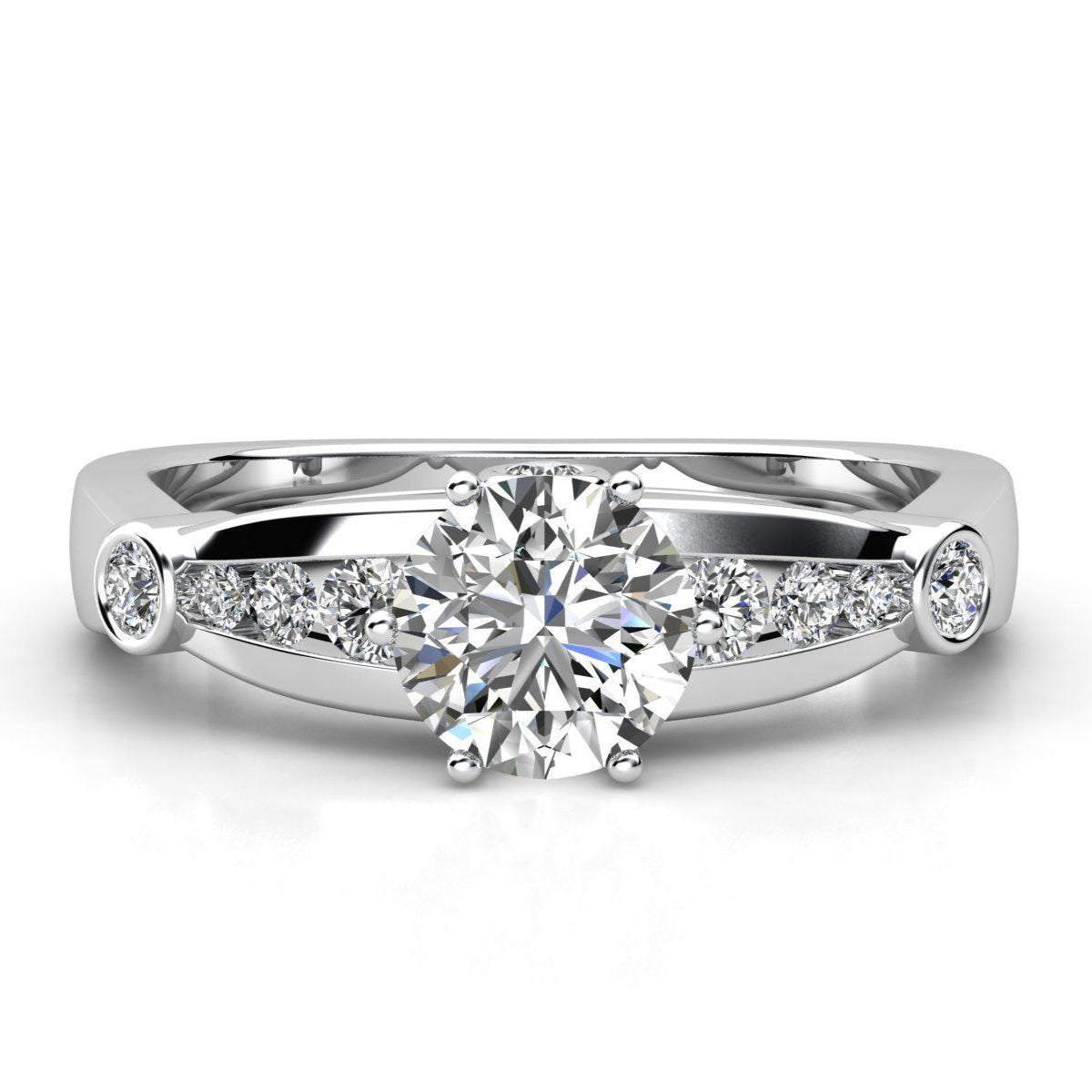 Emmarie Diamond Ring in white gold or platinum with a round solitaire diamond, accented by a row of smaller diamonds along the band for added brilliance.